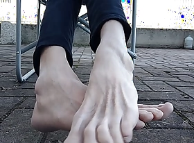 Showing my paws coupled with soles outdoors